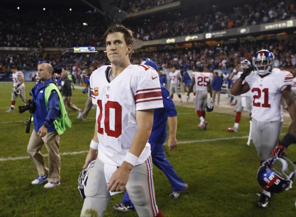 Eli Manning walks off the field after throwing three interceptions in the Giants' 27-21 loss to the Bears Thursday night. (Charles Rex Arbogast/AP) 