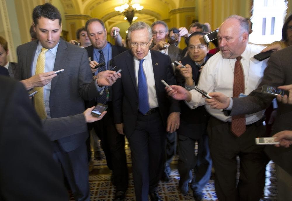 Senate Majority Leader Sen. Harry Reid, D-Nev., is surrounded by reporters after leaving the office of Senate Minority Leader Sen. Mitch McConnell, R-Ken., on Capitol Hill on Monday, Oct. 14, 2013 in Washington. (Evan Vucci/AP)