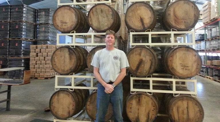 Matt Nadeu with bourbon oak barrels filled with the Russian imperial stout. (Jon Kalish) 