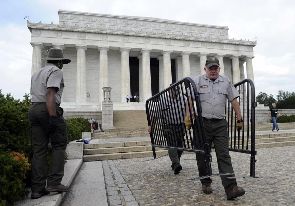 National Park Service employee James Mitchell, right, and others, remove barricades from the grounds of the Lincoln Memorial in Washington, Thursday, Oct. 17, 2013..(AP /Susan Walsh)