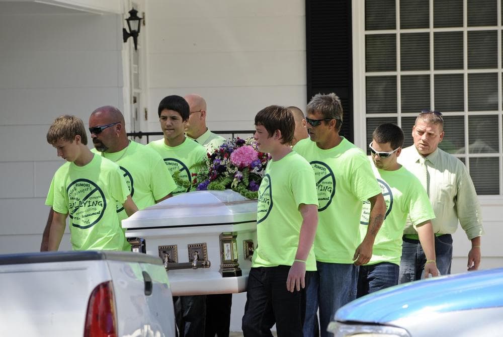 Pallbearers wearing anti-bullying t-shirts carry the casket of Rebecca Sedwick,12, to a waiting hearse as they exit the Whidden-McLean Funeral Home Monday, Sept. 16, 2013, in Bartow, Fla. (AP/Brian Blanco)
