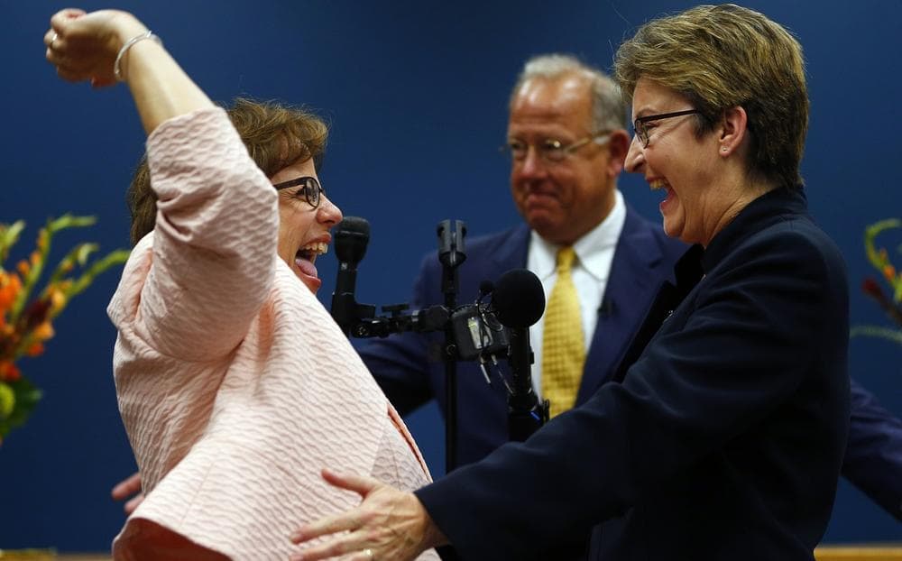 Beth Asaro, left, and Joanne Schailey, right, became the first same-sex couple to be married in Lambertville, N.J. history at 12:01 a.m. Monday, Oct. 21, 2013. Lambertville Mayor David DelVecchio, center, officiated. (Rich Schultz/AP)