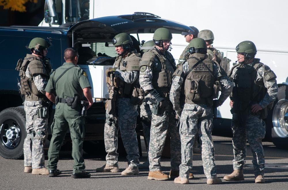 Swat team members secure the scene near Sparks Middle School in Sparks, Nev., after a shooting there on Monday, Oct. 21, 2013. Authorities are reporting that two people were killed and two wounded at the Nevada middle school. (Kevin Clifford/AP)