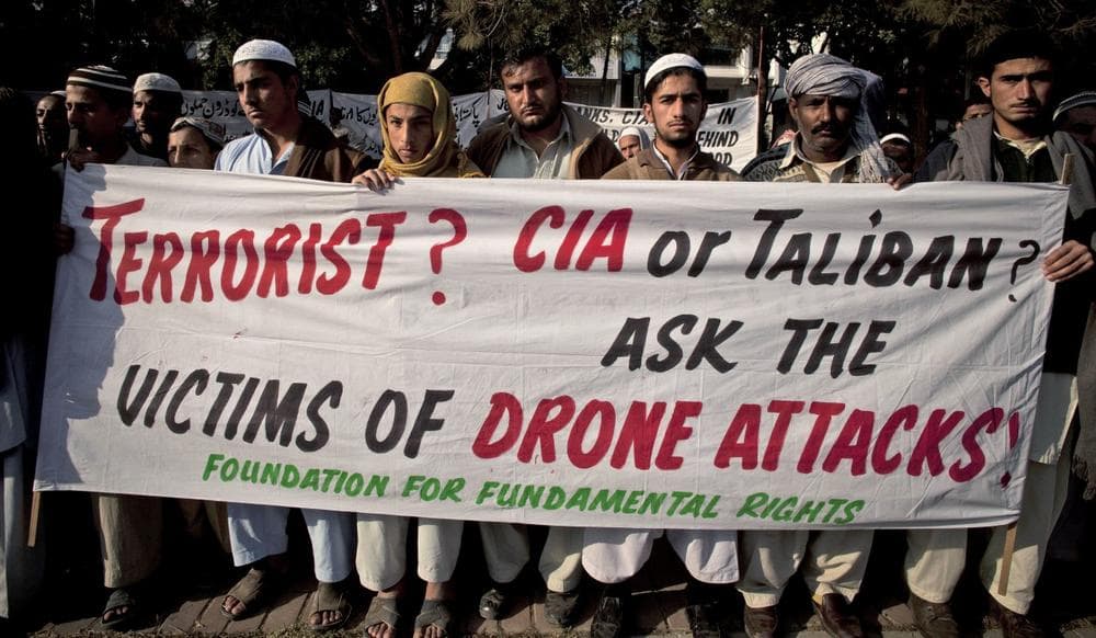 In this Friday, Dec. 10, 2010 file photo, Pakistani tribal villagers hold a rally to condemn the U.S. drone attacks on their villages in border areas along the Afghanistan border, in Islamabad, Pakistan. Amnesty International calls on the U.S. to investigate reported civilian casualties from CIA drone strikes in Pakistan and compensate victims in a report providing new details about innocent citizens allegedly killed in the attacks. (B.K. Bangash/AP)