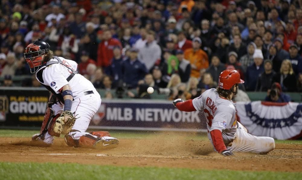 The Cardinals’ Pete Kozma scores on a sacrifice fly as Red Sox catcher Jarrod Saltalamacchia can’t handle the throw during the seventh inning of Game 2 of the World Series on Thursday. In an evolving St. Louis, the Cardinals remain a point of pride. (Matt Slocum/AP)