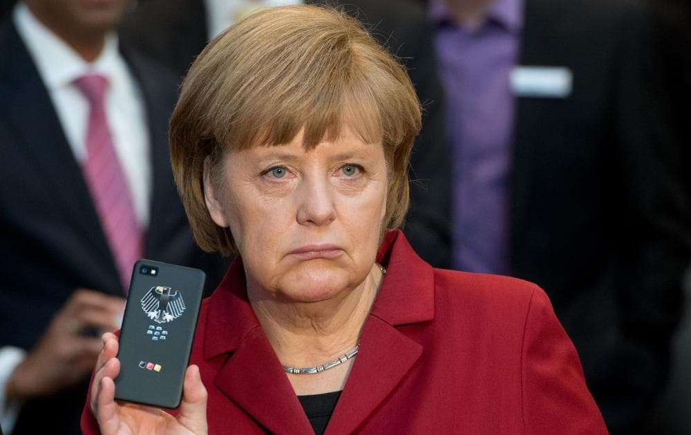 German Chancellor Angela Merkel presents a Blackberry tap-proof mobile phone at a booth of Secusmart during the opening round tour of the world's largest computer expo CeBIT in Hannover, in March 2013. Merkel complained to President Barack Obama on Wednesday, Oct. 23, 2013 after learning that U.S. intelligence may have targeted her mobile phone. (Julian Stratenschulte/dpa via AP)
