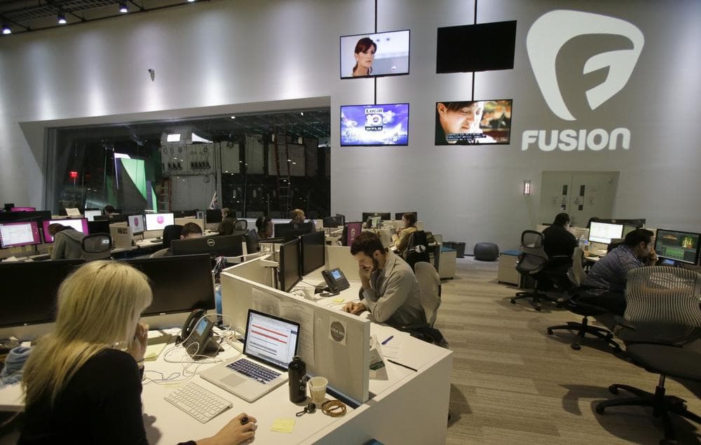 Workers are shown in the Fusion network's warehouse-turned-news hub known as Newsport, in Doral, Fla, Oct. 14, 2013. The English-language television network is targeting millennial Hispanics. (Wilfredo Lee/AP)