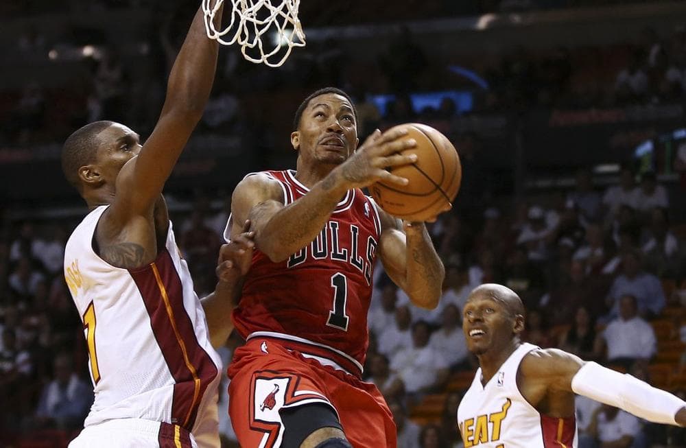 Chicago Bulls&#039; Derrick Rose (1) goes to the basket between Miami Heat&#039;s Chris Bosh (1) and Ray Allen (34) during the second half of an NBA basketball game in Miami, Tuesday, Oct. 29, 2013. (J Pat Carter/AP)