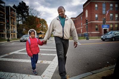 Troy Elder walks his granddaughter, Soley, across Babson Street after school from the Pope John Paul II School. (Jesse Costa/WBUR)