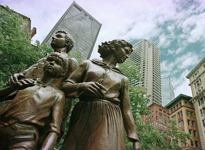 A sculpture, which is part of the Boston Irish Famine Memorial, depicts a hopeful Irish family landing in Boston. (Victoria Arocho/AP)