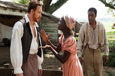 Plantation owner Edwin Epps (Michael Fassbender) addresses his slave, Patsey (Lupita Nyong'o) as Solomon Northrup (Chiwetel Ejiofor) looks on in the 2013 film, &quot;12 Years A Slave.&quot; (Fox Searchlight Pictures)