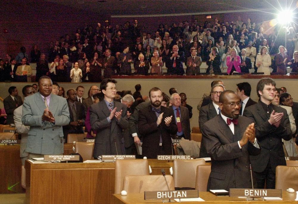 Supporters applaud as Hans Corell, the UN under secretary-general for legal affair announces the ratification of the Rome treaty, which establishes the International Criminal Court Thursday, April 11, 2002 at the United Nations headquarters in New York Thursday April 11, 2002. (Osamu Honda/AP)