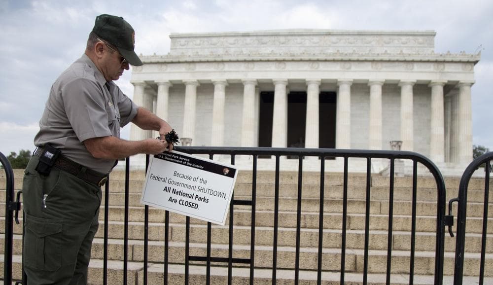 A National Park Service employee posts a sign on a barricade to close access to the Lincoln Memorial in Washington, Tuesday, Oct. 1, 2013. Congress plunged the nation into a partial government shutdown Tuesday as a long-running dispute over President Barack Obama's health care law stalled a temporary funding bill, forcing about 800, 000 federal workers off the job and suspending most non-essential federal programs and services. (AP)