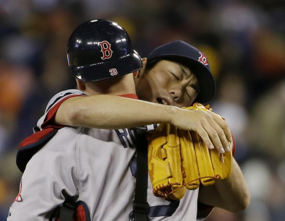Boston Red Sox's Koji Uehara celebrates with David Ross after the Red Sox defeating the Detroit Tigers 4-3 in Game 5 of the American League baseball championship series Thursday, Oct. 17, 2013, in Detroit. (AP)