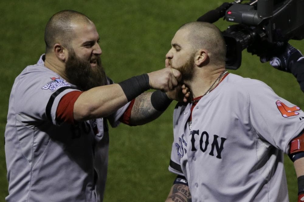 Boston Red Sox Mike Napoli, right, pulls Jonny Gomes' beard after Gomes hit a three run home run off of St. Louis Cardinals relief pitcher Seth Maness, left, during the sixth inning of Game 4 of baseball's World Series Sunday, Oct. 27, 2013, in St. Louis.(AP)