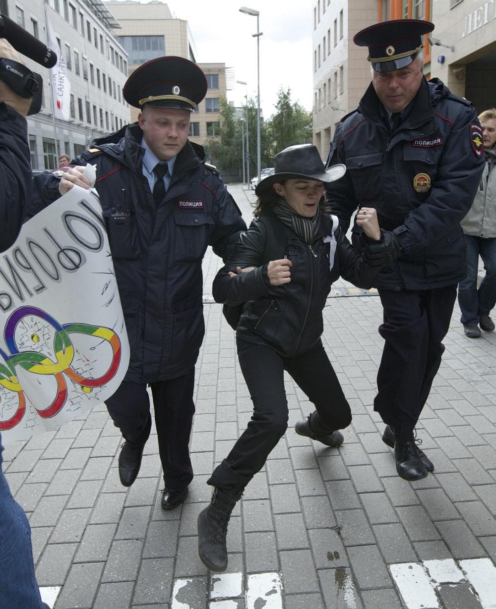 Russian police officers detain a gay rights activist during a protest outside the Sochi 2014 Winter Olympic Games organizing committee office, in Moscow, Russia, on Wednesday, Sept. 25, 2013.  (Ivan Sekretarev/AP)