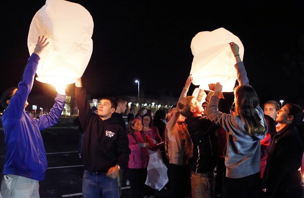Danvers High School students prepare to launch sky lanterns during a candlelight vigil to mourn the death of Colleen Ritzer, a 24-year-old math teacher at the school, on Wednesday, Oct 23, 2013, in Danvers, Mass. (AP/Bizuayehu Tesfaye)