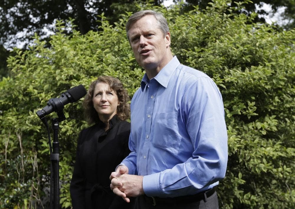 Republican gubernatorial candidate Charles Baker and his wife Lauren outside their Swampscott home. (AP/Steven Senne)