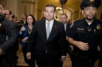Sen. Ted Cruz, R-Texas, walks with security after talking to reporters on Capitol Hill, Wednesday, Oct. 16, 2013, in Washington. Sen. McConnell and his Democratic counterpart, Senate Majority Leader Harry Reid, D-Nev., are optimistic about forging an eleventh-hour bipartisan deal preventing a possible federal default and ending the partial government shutdown after Republican divisions forced GOP leaders to drop efforts to ram their own version through the House. (AP)