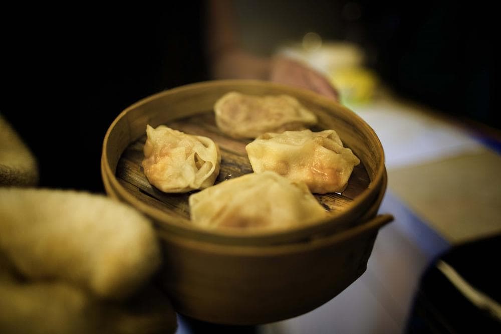 Author Jen Lin-Liu presents some of the manta dumplings she prepared in the WBUR studios on Oct. 8, 2013. (WBUR)