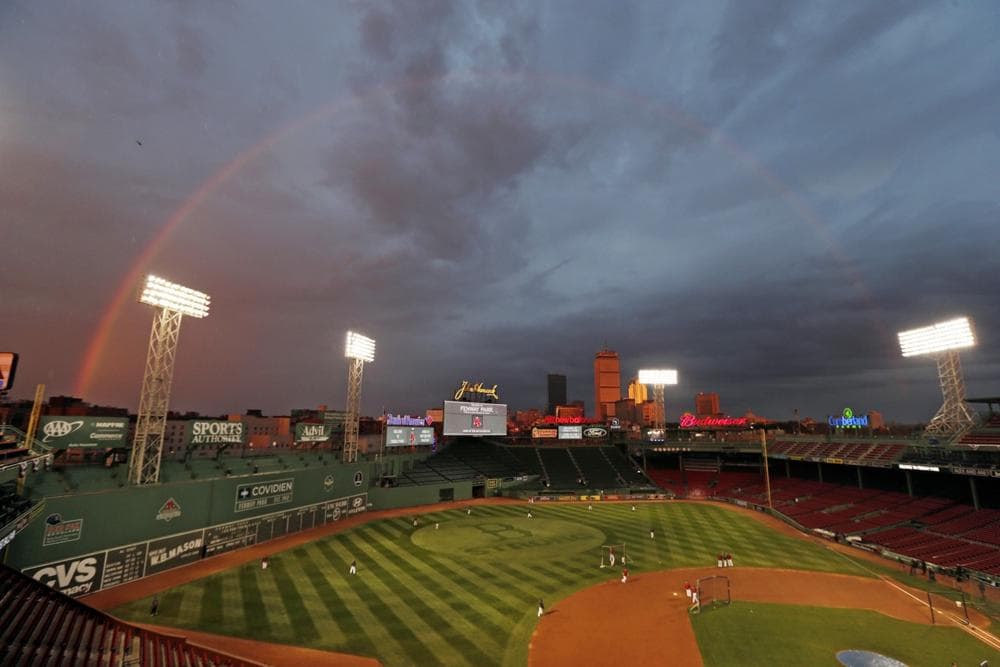 A rainbow appeared in the sky above Fenway Park Tuesday as the Red Sox players took batting practice. (Charles Krupa/AP)