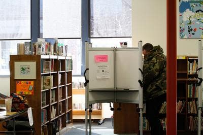 A voter casts his ballot at Edith Fox Library in Arlington, Mass., March 2012. (Credit: Dana Hansen, Boston University News Service)