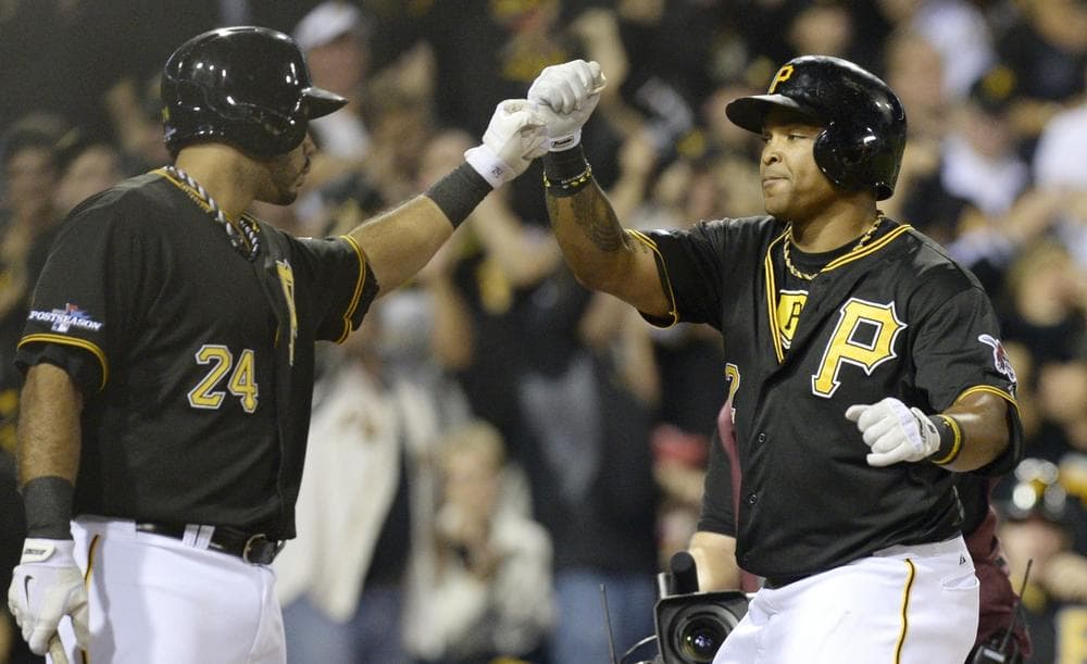 Pittsburgh Pirates' Marlon Byrd, right, is greeted by teammate Pedro Alvarez after hitting a home run in the second inning of the NL wild-card playoff baseball game against the Cincinnati Reds on Tuesday, Oct. 1, 2013, in Pittsburgh. (AP)