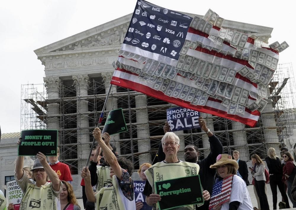 Demonstrators gather outside the Supreme Court in Washington, Tuesday, Oct. 8, 2013, as the court heard arguments on campaign finance. The Supreme Court is tackling a challenge to limits on contributions by the biggest individual donors to political campaigns. (AP)