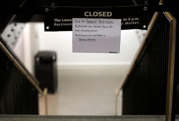 A sign on Tuesday informs visitors to Boston’s Faneuil Hall, the nation’s oldest public meeting hall, that restrooms are closed as a result of the partial government shutdown. (Stephan Savoia/AP)