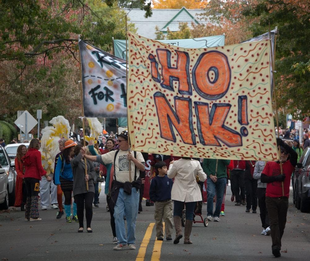 Banners calling for people to “Reclaim the streets for horns, bikes, and feet” lead the parade. (Greg Cook)
