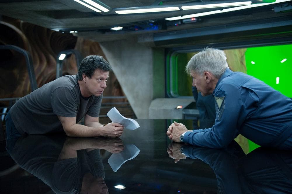 Director and screenwriter Gavin Hood (left) talks with Harrison Ford, who plays Colonel Graff on the set of the new movie &quot;Ender's Game.&quot; (Richard Foreman Jr., SMPSP, © 2013 Summit Entertainment, LLC. All Rights Reserved.)