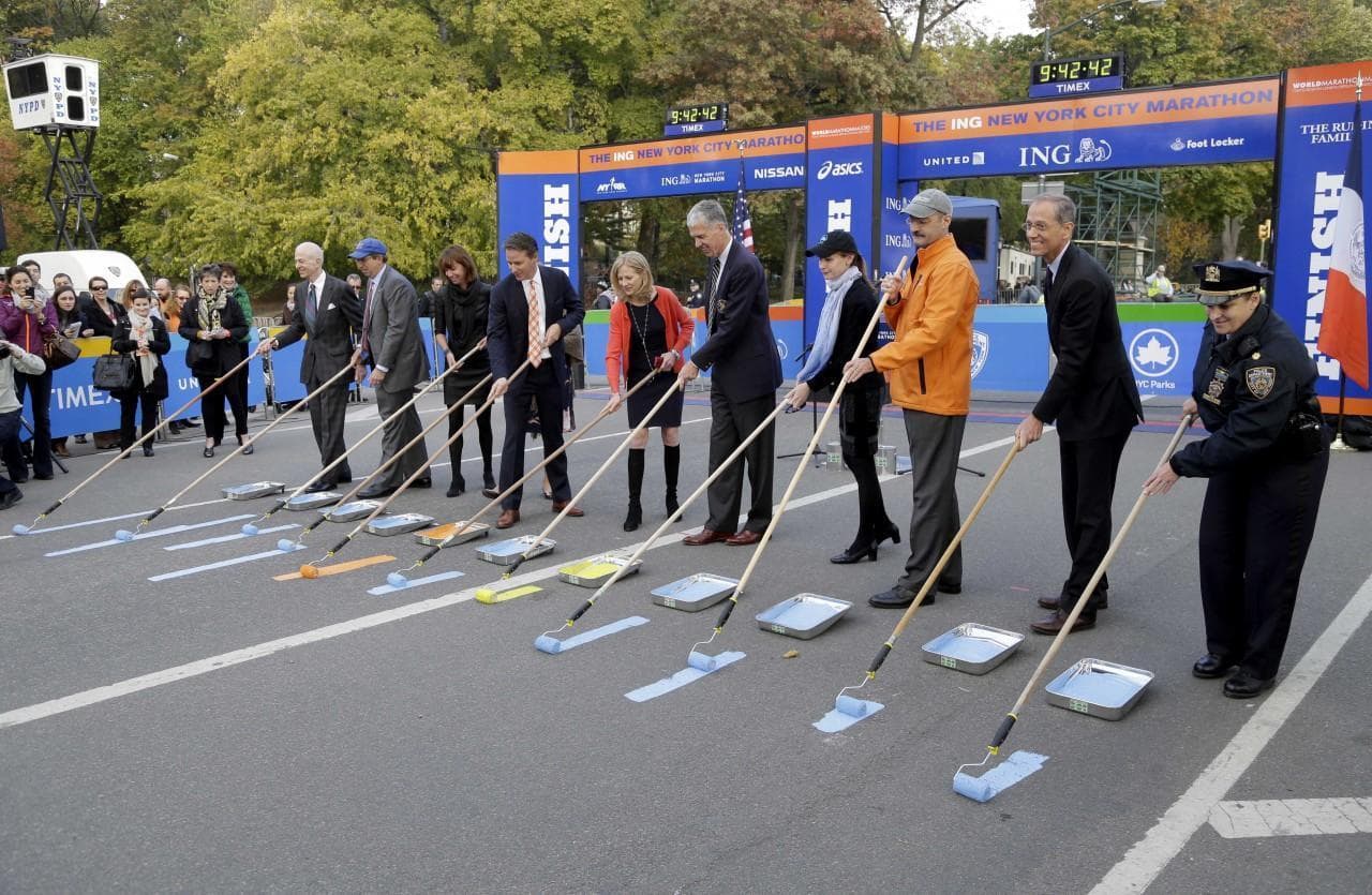 The ceremonial painting of the NYC Marathon course line included a yellow line to honor victims and first responders of the 2013 Boston marathon bombings. (Seth Wenig/AP)