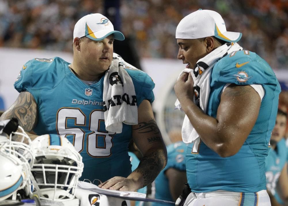 Miami Dolphins guard Richie Incognito (68) and tackle Jonathan Martin (71) at an NFL preseason football game against the Tampa Bay Buccaneers, Saturday, Aug. 24, 2013 in Miami Gardens, Fla. Incognito has been suspended over allegations that he bullied Martin. (Wilfredo Lee/AP)