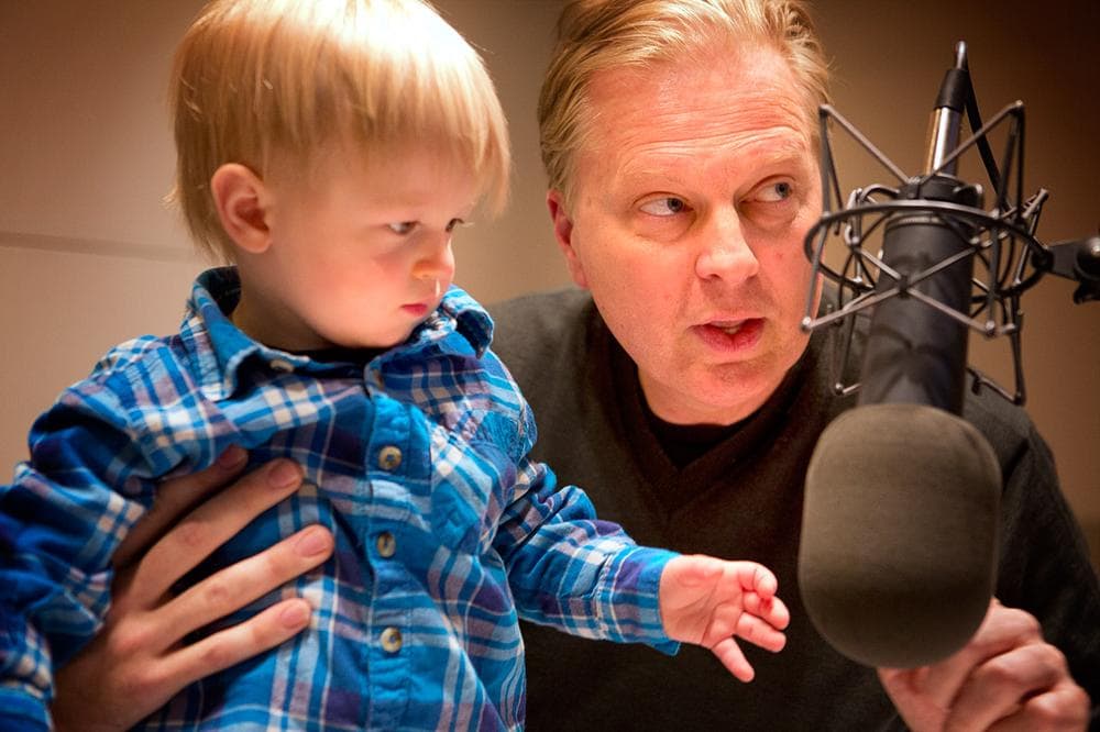 Host Tom Ashbrook shows Nolan where to stand in order to reach the studio's mic. (WBUR)