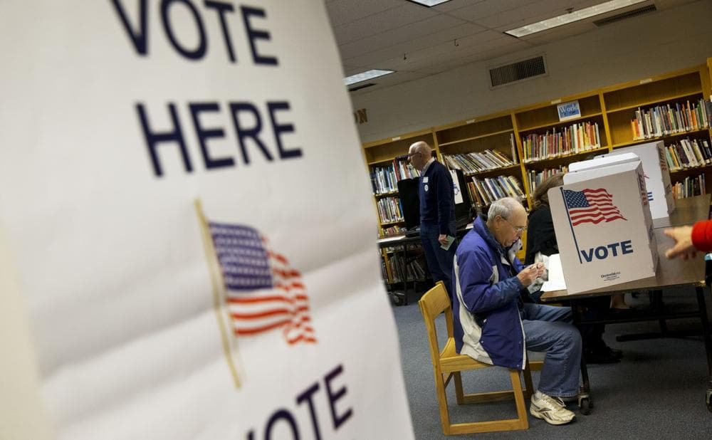 Steve Maskell of McLean, Va., right, votes in an election that includes the Virginia gubernatorial race between Republican Ken Cuccinelli and Democrat Terry McAuliffe on election day in McLean, Va., Tuesday, Nov. 5, 2013. (Jacquelyn Martin/AP)