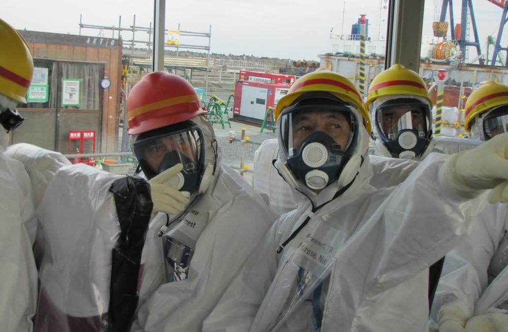 U.S. Energy Secretary Ernest Moniz, left, listens to TEPCO President Naomi Hirose, as he tours the facilities at the Fukushima Daiichi nuclear power plant, Friday, Nov. 1, 2013. (Tokyo Electric Power Co.)