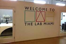 A warm greeting on the wall of office space inside The Lab Miami. (Marie Gilot/WLRN)