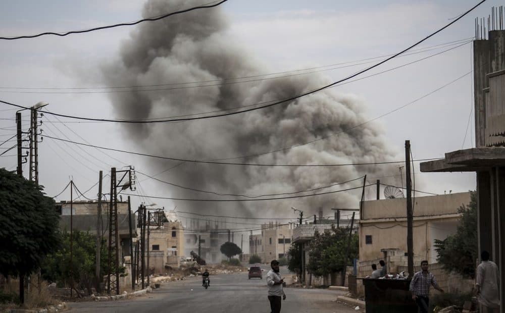 Smoke rises after an air strike, Sept. 22, 2013, in a village that has been turned into a battlefield between Free Syrian Army fighters and government forces in Idlib province, northern Syria. (Narciso Contreras/AP)