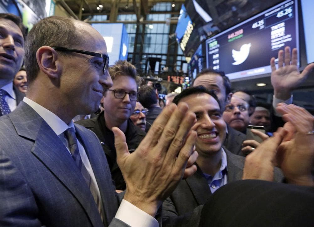 Twitter CEO Dick Costolo, left, co-founder Biz Stone, center, and Amir Movafaghi, right, Twitter's Director of Treasury and Strategic Finance, applaud as shares begin trading in their IPO, on the floor of the New York Stock Exchange, Thursday, Nov. 7, 2013. (Richard Drew/AP)