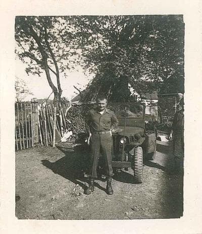 Raymond Allen Ashlock stands in front of a Jeep in Czechoslovakia.