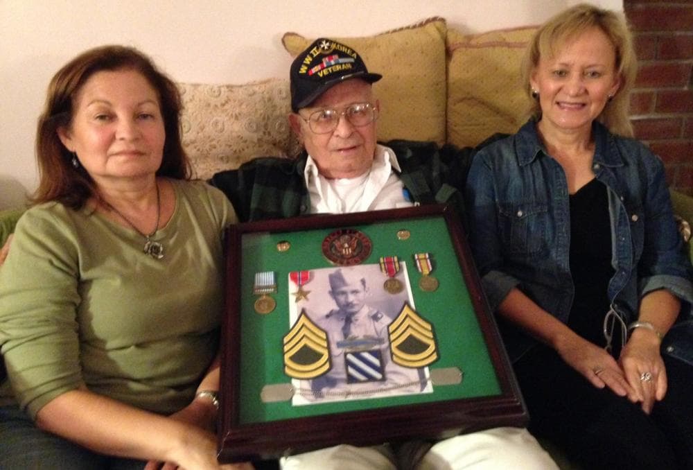 World War II veteran Luis Rodriguez, 91, is pictured with his daughters, Judy and Beth. (Lucy Nalpathanchil/WNPR) 