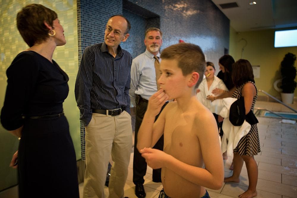 Stuart Supple, 10, foreground, and his brother, Timmy, love spending time in pools. That’s why their mother, Kate, left, thought it would be the best place for them to meet Dr. Thomas Sudhof, the man who’s been studying their genes for five years. (Jesse Costa/WBUR)