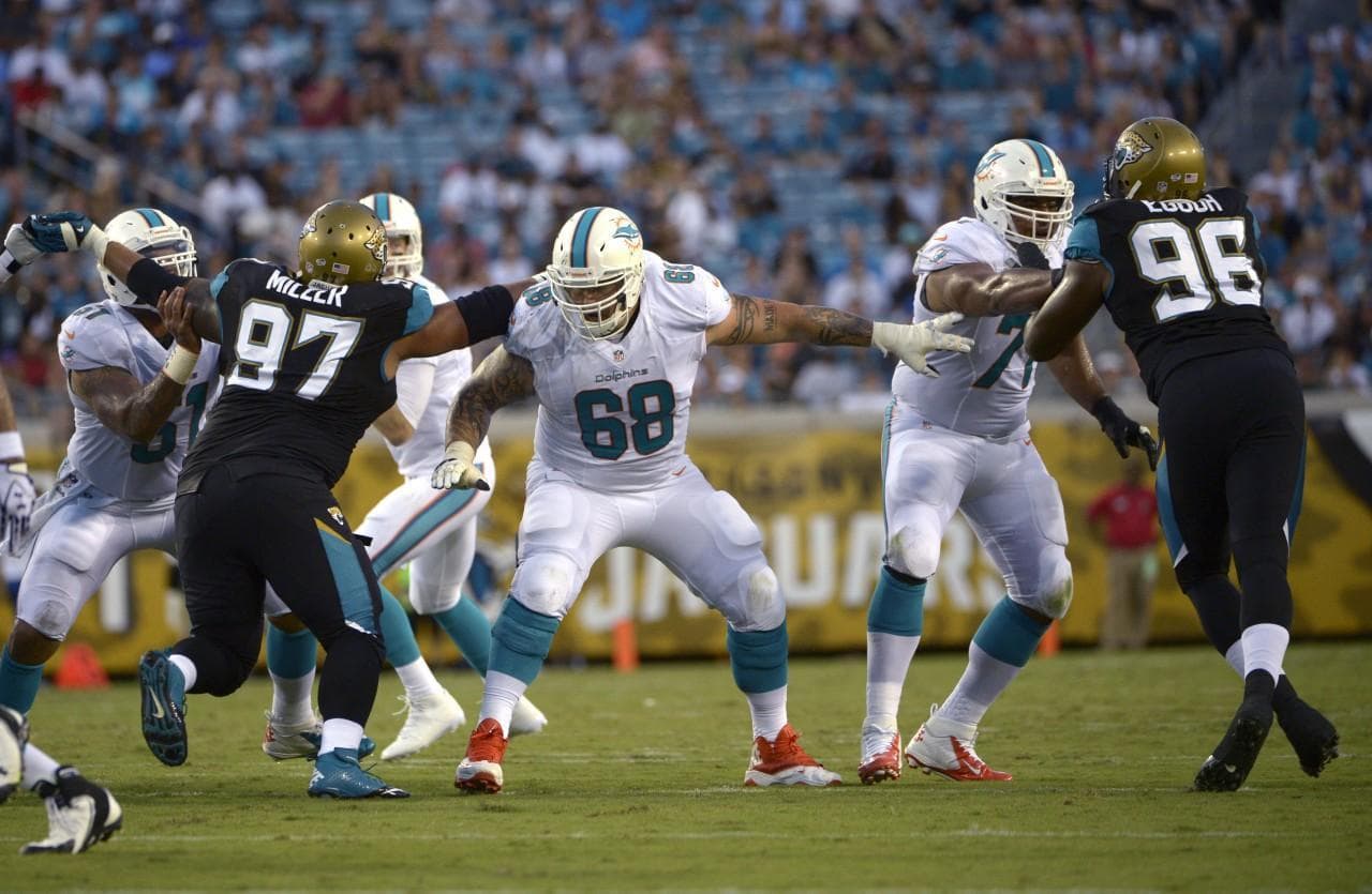 Richie Ingonito (68) and Jonathan Martin (71) worked together on the field, but behind the scenes their relationship was more complicated. (Phelan M. Ebenhack/AP)