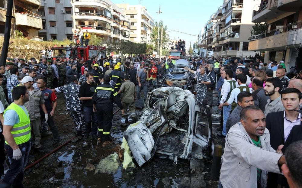 Lebanese people gather at the scene where two explosions have struck near the Iranian Embassy killing many, in Beirut, Lebanon, Tuesday, Nov. 19, 2013. (Bilal Hussein/AP)