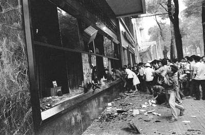 Rioting South Vietnamese civilians smash shop windows in Saigon, Vietnam on Nov. 5, 1963 during military coup that toppled the regime of President Ngo Dinh Diem. (AP)
