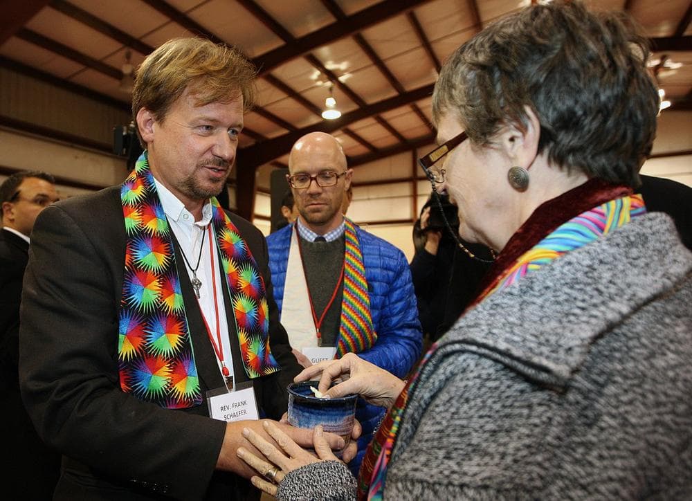 The Rev. Frank Schaefer, left, of Lebanon Pa., celebrates communion with supporters after the sentencing phase of the trial at Camp Innabah, a United Methodist retreat, in Spring City Pa. Tuesday Nov. 19, 2013. (Chris Knight/AP)