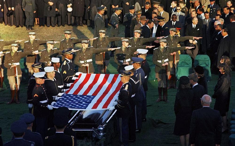 The Irish cadet honor guard, center rows with arms outstretched, stand in formation as the U.S. flag is lifted from the coffin of President John F. Kennedy during his funeral services at Arlington National Cemetery in Arlington, Va., Nov. 25, 1963. (AP)
