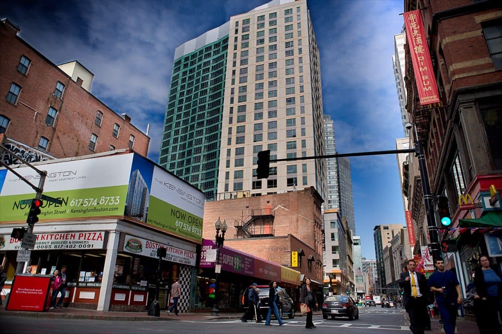 The Kensington apartments and Millenium Place condominiums, behind, tower over Chinatown at the intersection of Stuart, Kneeland and Washington streets in this 2013 file photo. (Jesse Costa/WBUR)
