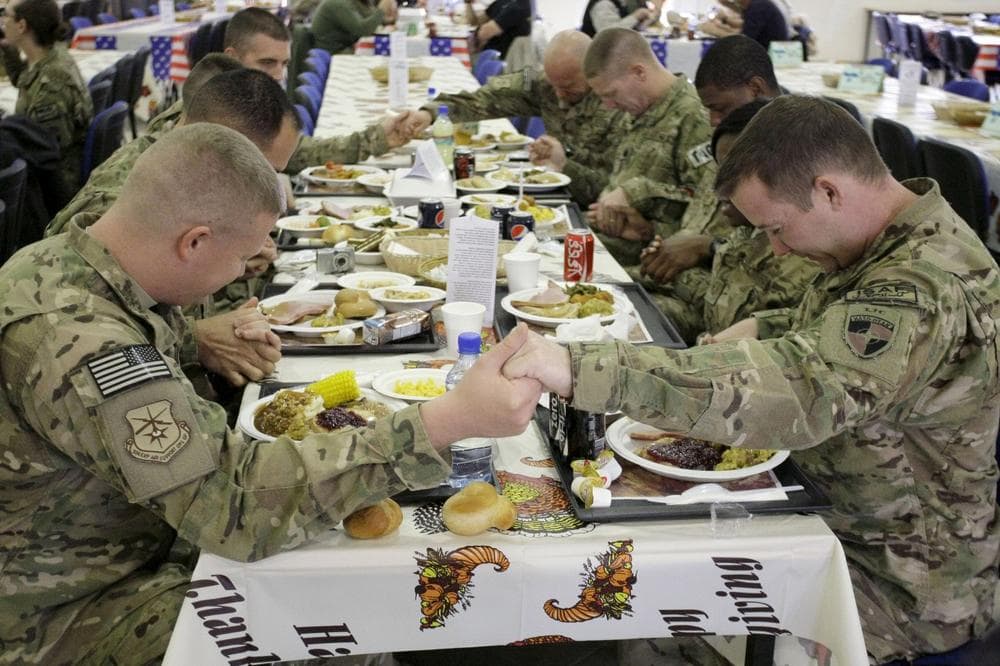 U.S. soldiers pray before eating a Thanksgiving meal at a dining hall at the U.S.-led coalition base in Kabul, Afghanistan, Thursday, Nov. 22, 2012. (Musadeq Sadeq/AP)