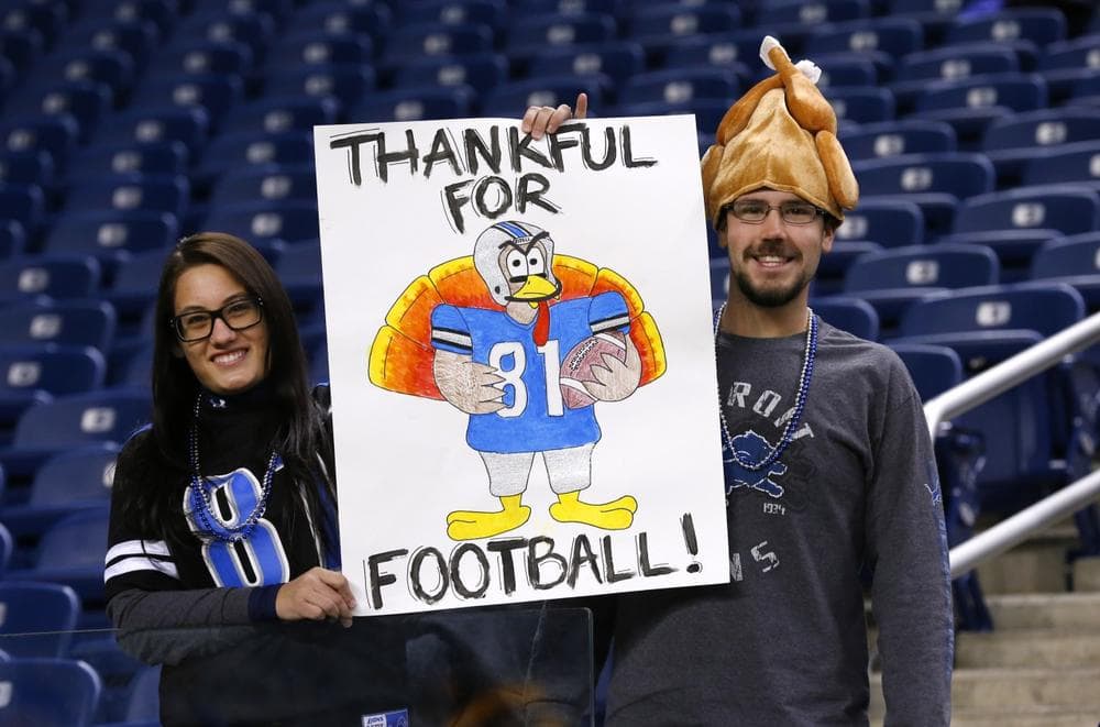 After the Lions managed a rare Thanksgiving Day win, Emily Goodin and her fiancé Ryan Cassell had even more reasons to be thankful.  (Paul Sancya/AP)